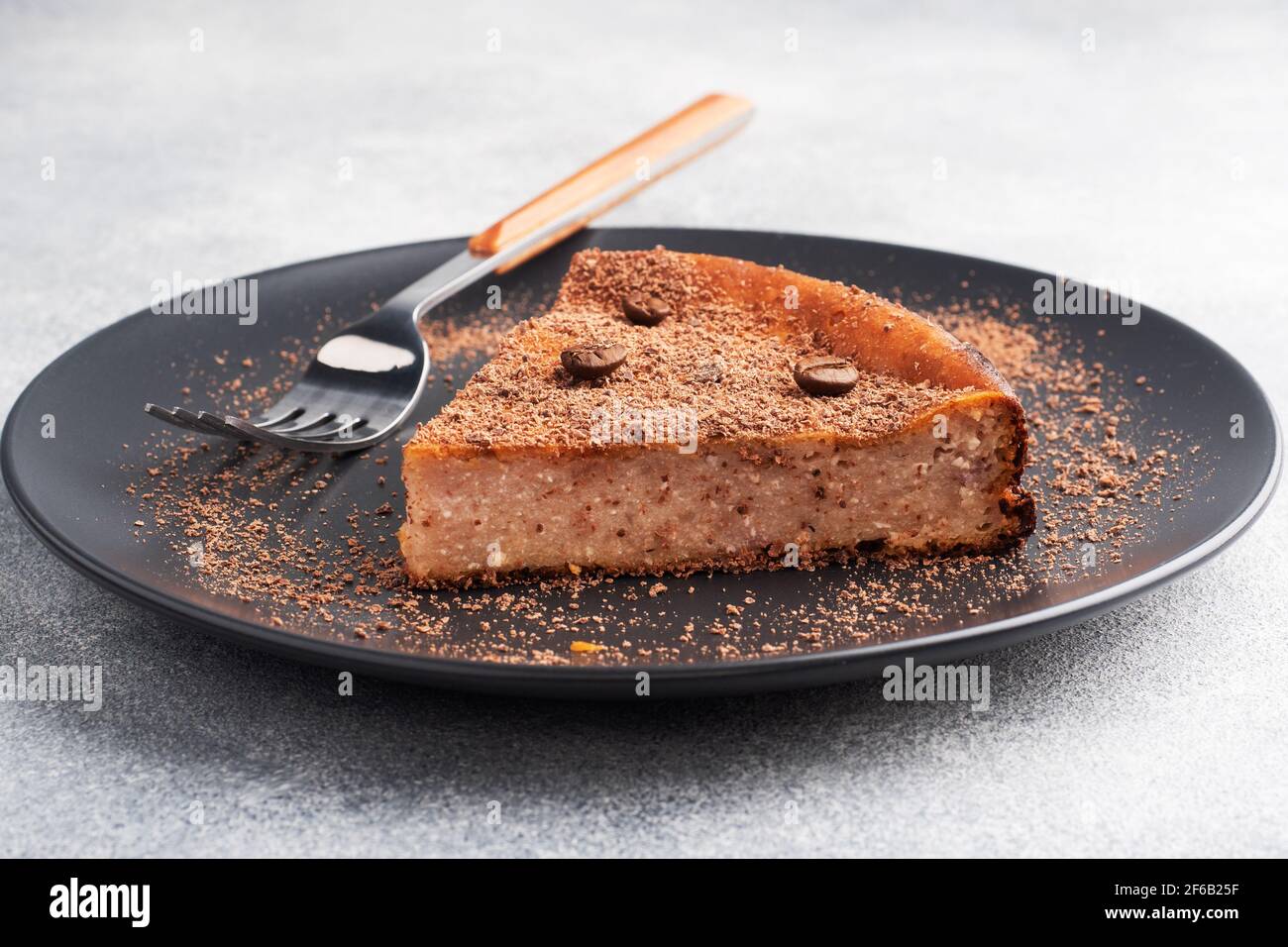Slice of chocolate curd casserole on a plate, a portion piece of cake with chocolate and coffee Stock Photo