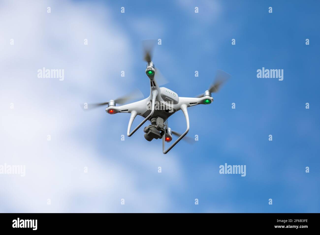 Drone quadrocopter with high resolution digital camera on the sky background. Stock Photo