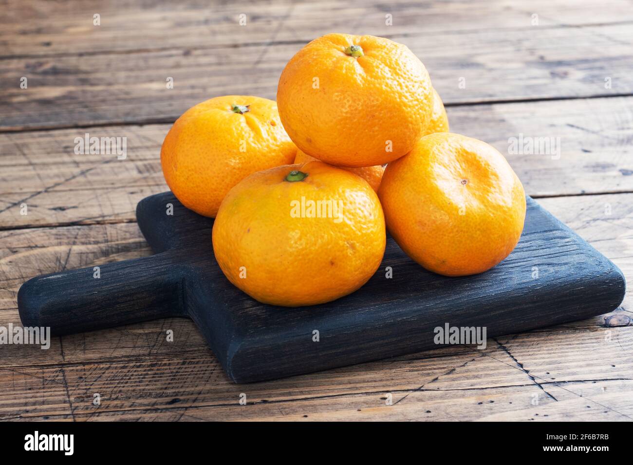 Oranges tangerines or mandarins clementines, citrus fruits on rustic wooden background, copy space Stock Photo