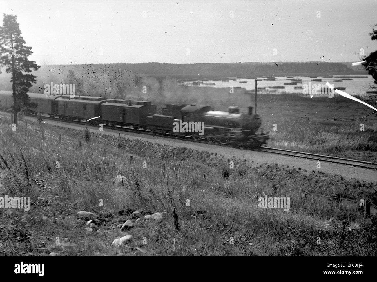 The state railways SJ B, with passenger train 414 on the line just north of Hille, Mårdängsjön's Bankeeper. The carriages are a catcher SJ C7B, previous SJ E3. Then a post cart SJ D01 later D022 originally from SWB.TT Stock Photo