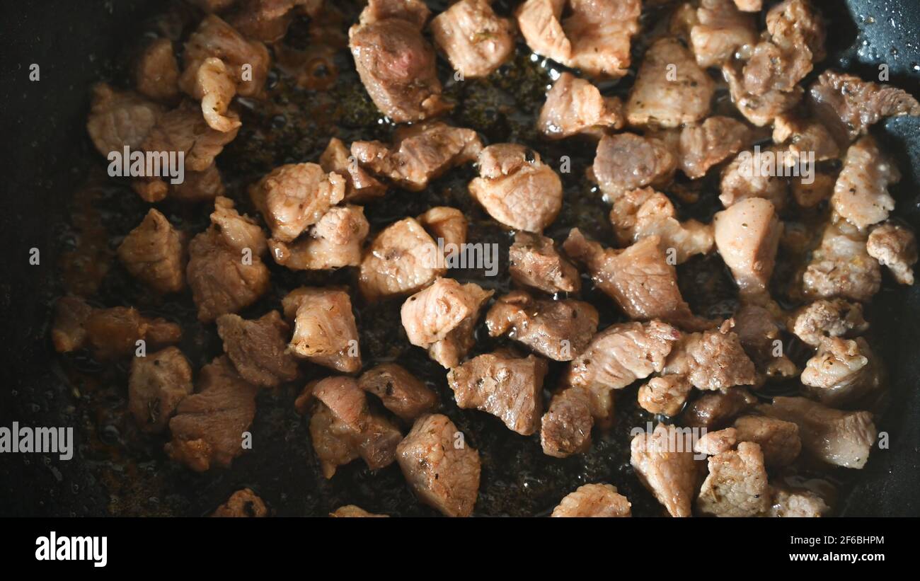 Pieces of meat are fried in a pan. Home kitchen. Close-up.  Stock Photo