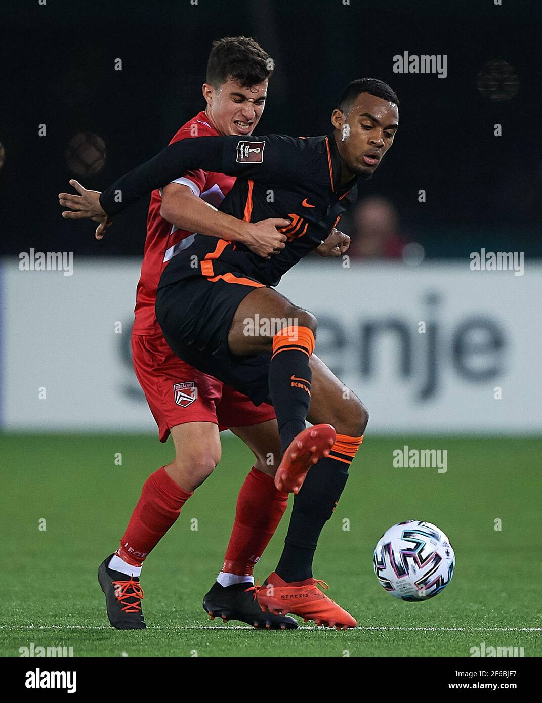Gibraltar. 30th Mar, 2021. Ryan Gravenberch (R) of the Netherlands vies with Kian Ronan of Gibraltar during the FIFA World Cup 2022 qualifying match between Gibraltar and the Netherlands in British Gibraltar, on March 30, 2021. Credit: Pablo Morano/Xinhua/Alamy Live News Stock Photo