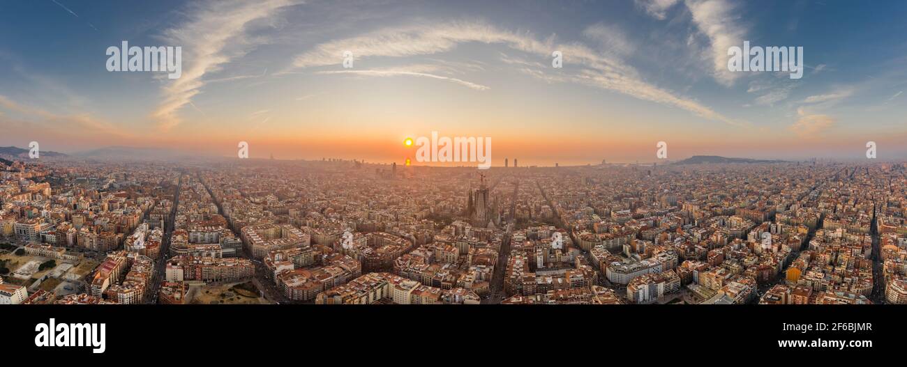 Barcelona, Spain - Feb 25, 2020: Aerial panorama shot of Barcelona coastline sun rising over horizon in winter morning Stock Photo