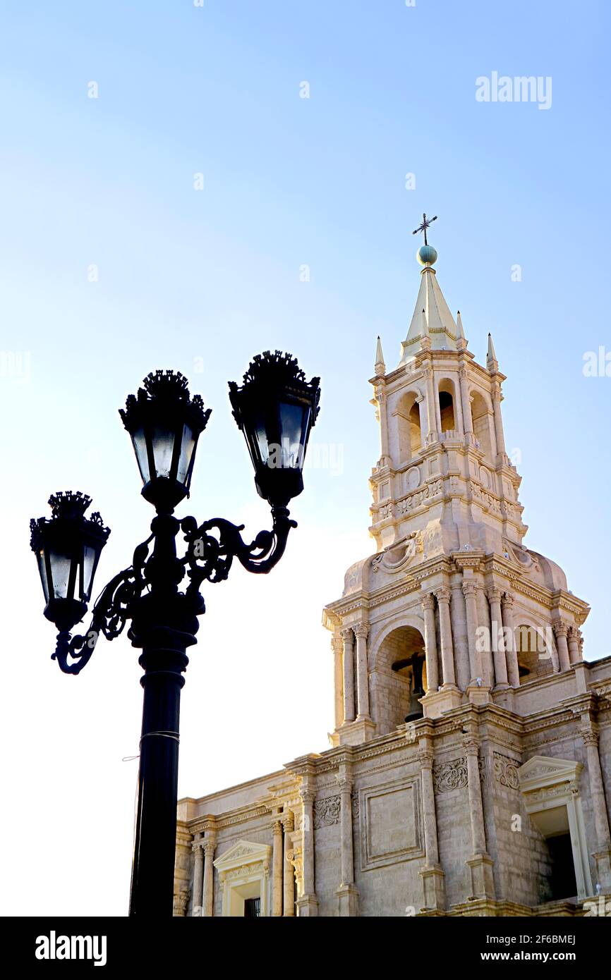 Gorgeous  White Volcanic Stone Bell Tower of Basilica Cathedral of Arequipa with Vintage Black Iron Lamppost, Arequipa, Peru Stock Photo