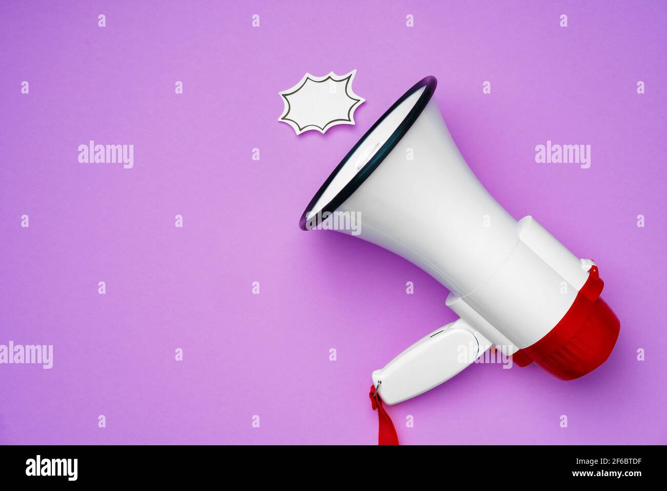 Electronic megaphone and speech bubble on purple background Stock Photo ...