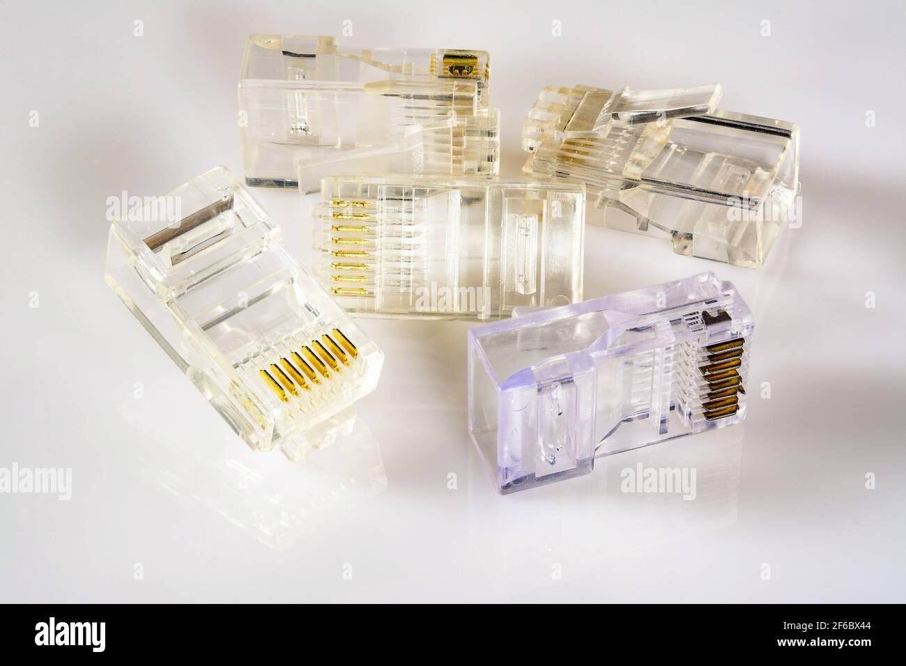 Connector rj-45. Five transparent connectors rj45 for network and internet. Close up macro on gloss white background with shadow. Stock Photo