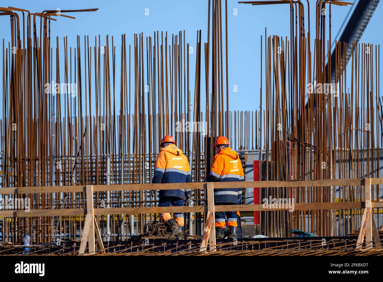 Unrecognizable builders walking on construction site Stock Photo