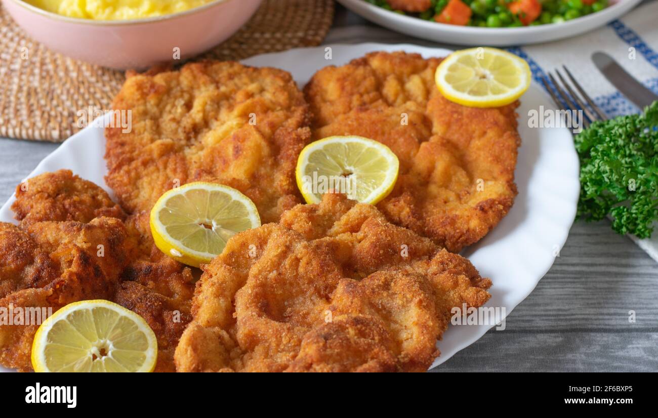 Vienna schnitzels on a plate for dinner on kitchen table from above ...