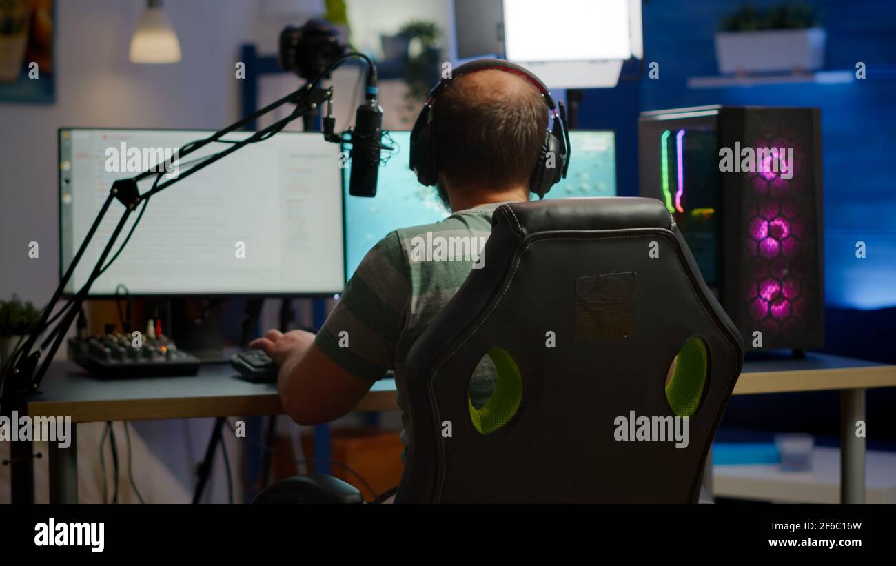 Premium Photo  Streamer man talking with multiple players into headphones  and winning video games competition. professional gamer streaming online  videogames with new graphics on powerful computer from gaming room