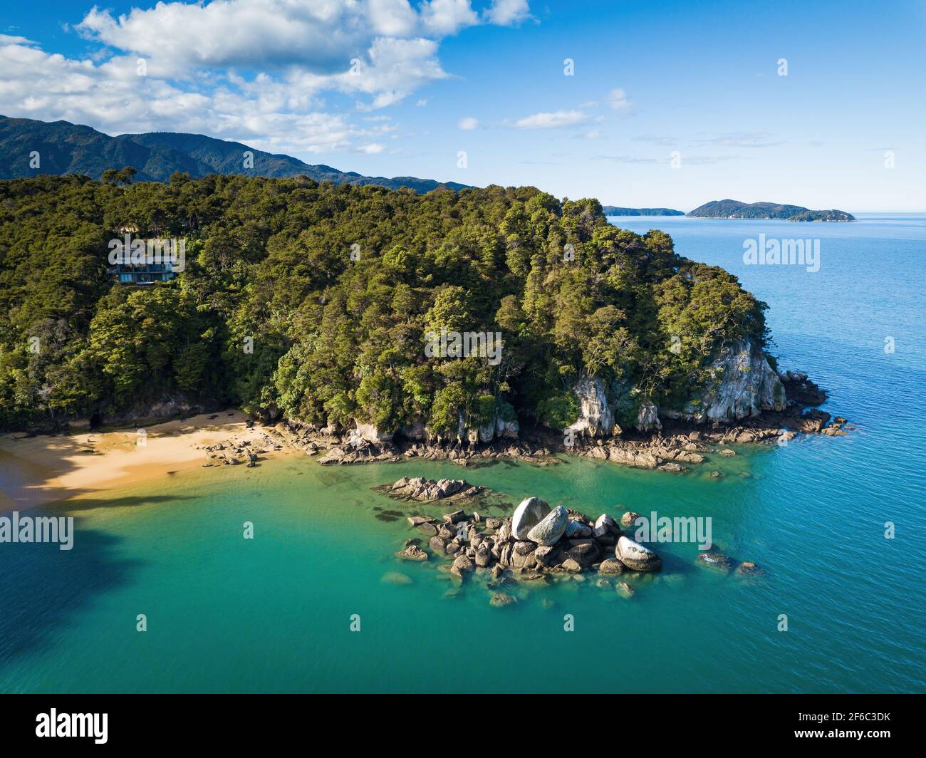 Drone view on rocky cape on tropical seacoast. Aerial view of New Zealand fantastic landscapes and scenery. Stock Photo