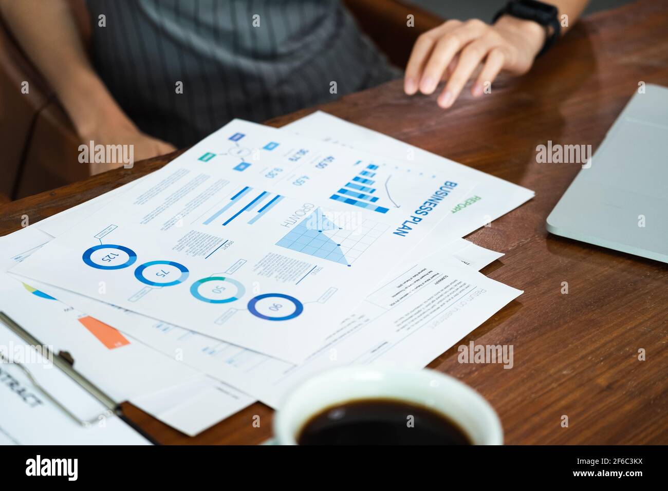 close up asian barista business owner show business plan to financial advisor about loan contract for open new restaurant business.small business entr Stock Photo