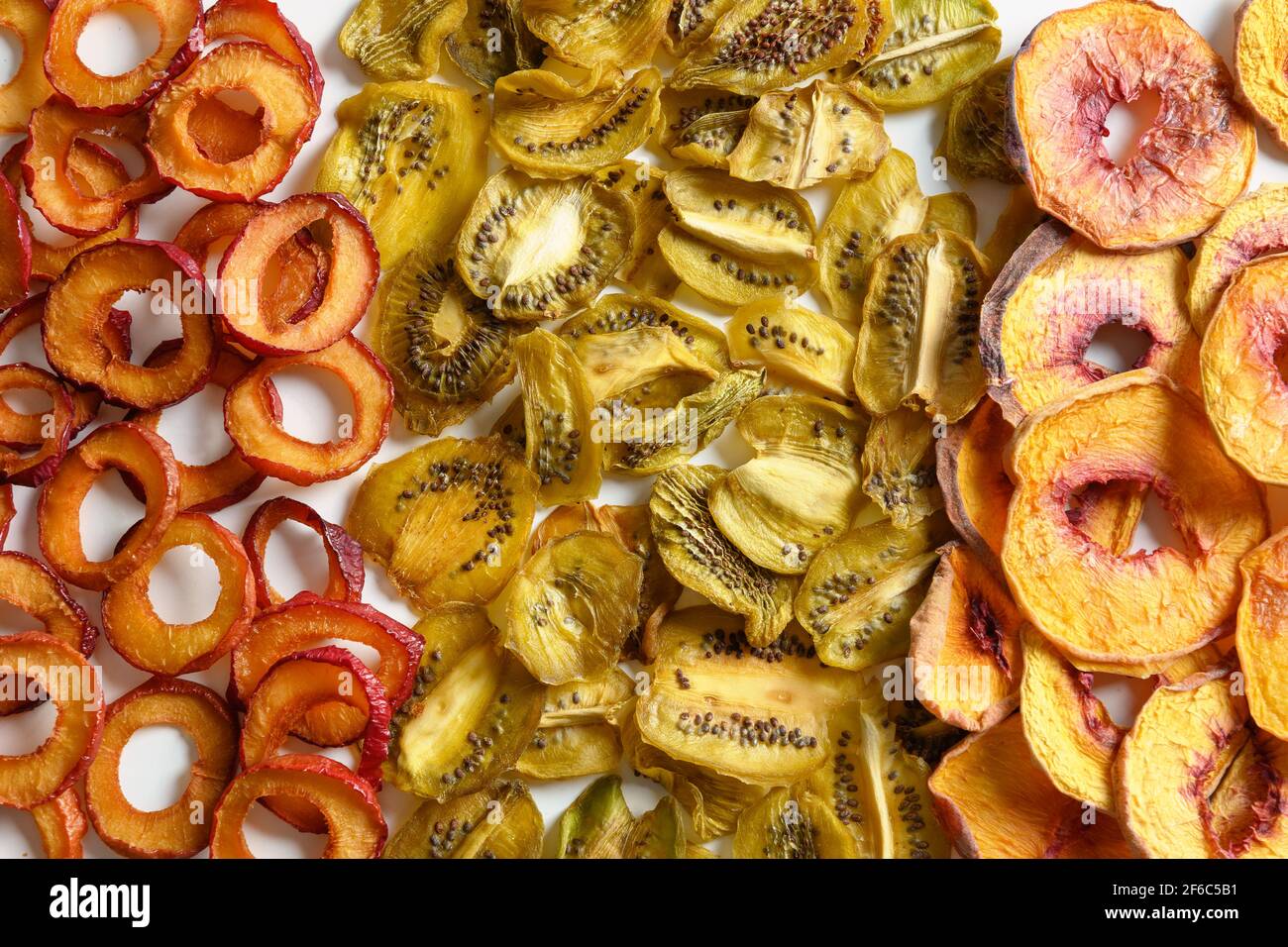Dried plums, kiwi, peach chips as food background. Fall harvest. Home