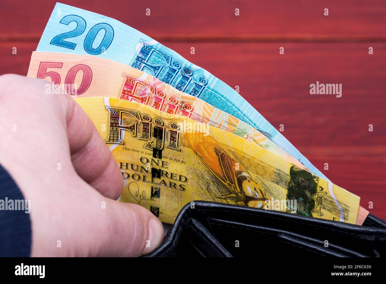 Money from Fiji in the black wallet Stock Photo