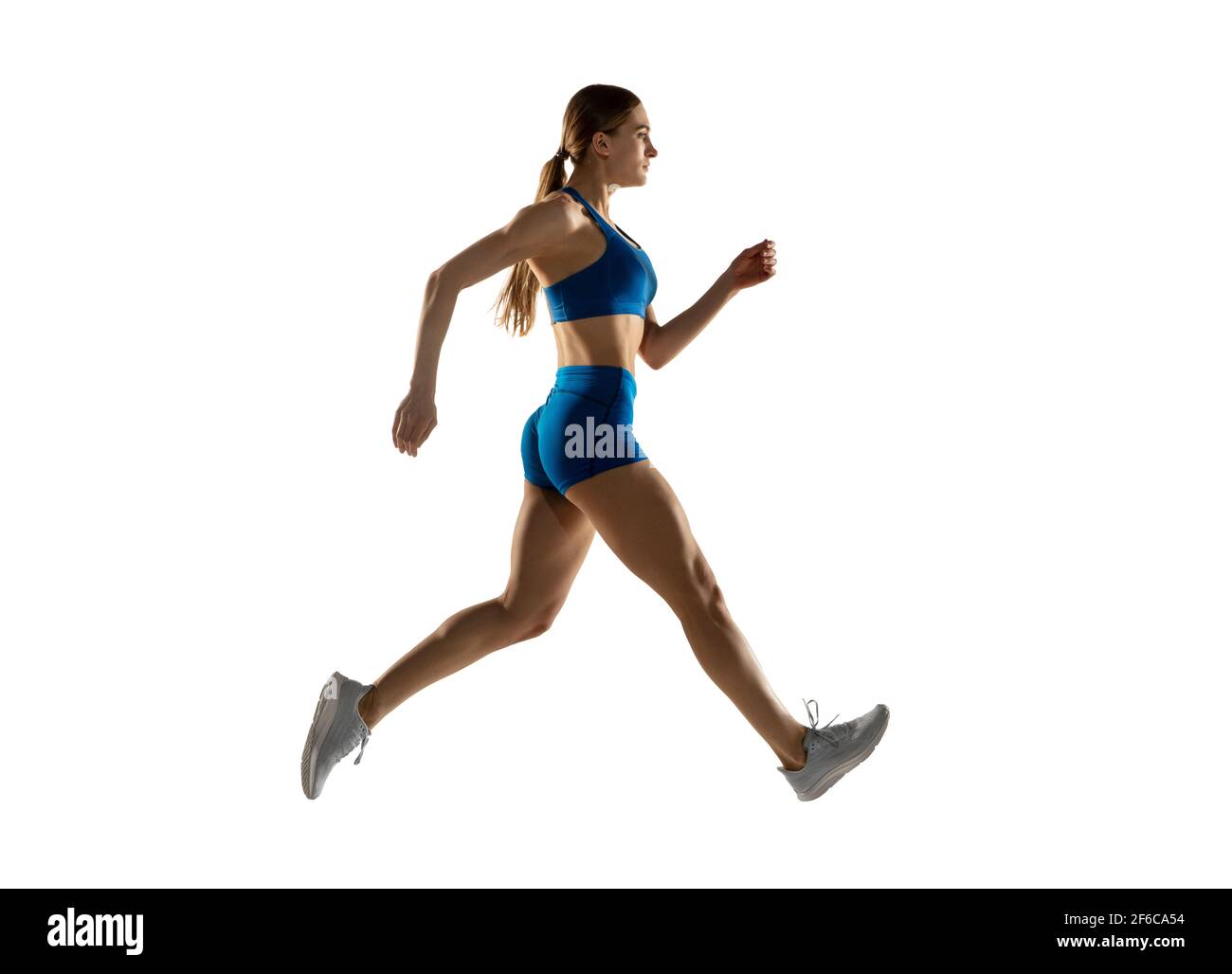 Young female track athlete training isolated over white studio