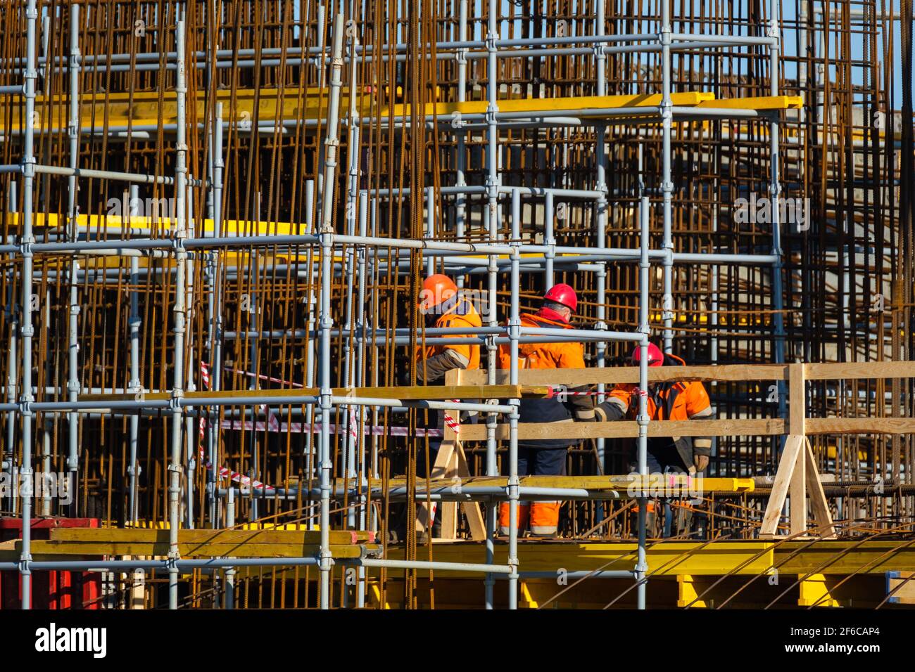 Unrecognizable builders walking on construction site Stock Photo