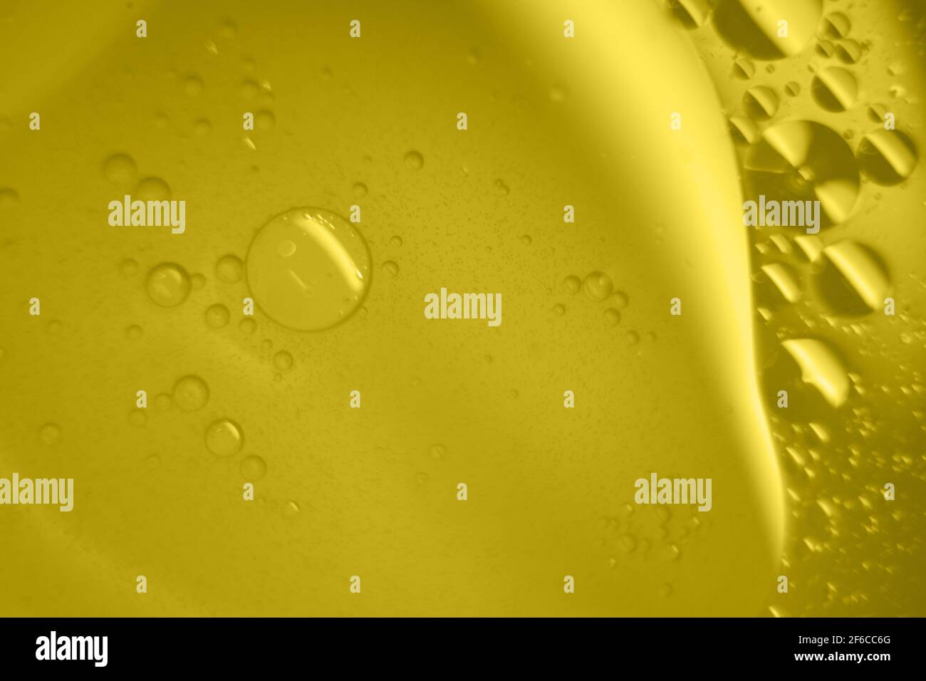 Macro fluid with bubbles, abstract yellow background. Selective focus. Stock Photo