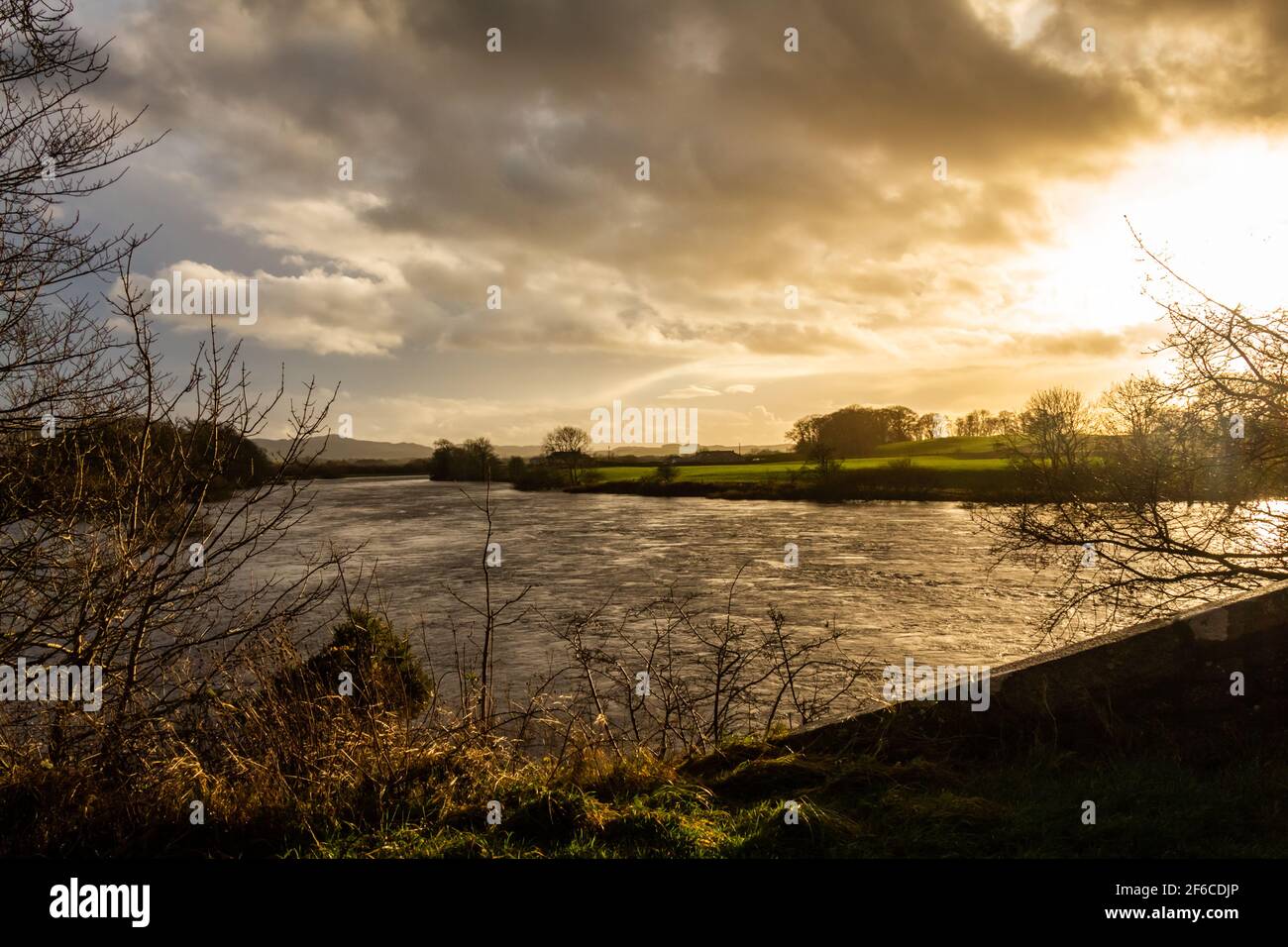 Sun setting over the River Dee at Glenlochar Bridge, on a winter afternoon, Dumfries and Galloway, Scotland Stock Photo