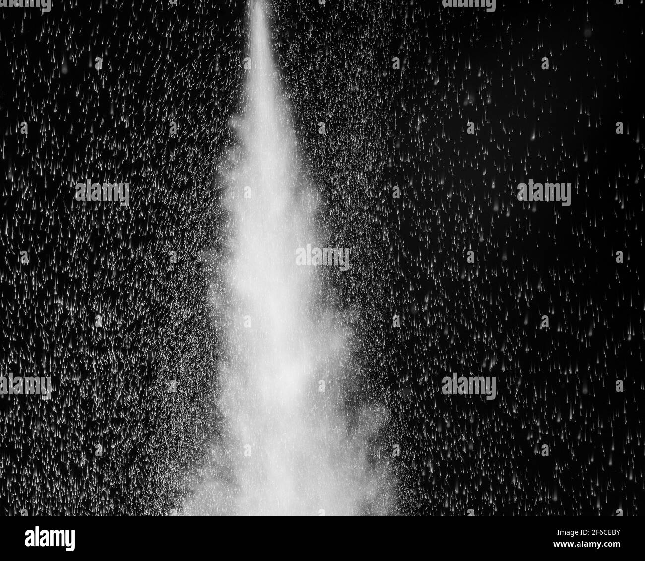 White steam and splashing water on a black background. Abstract background, design element. Stock Photo