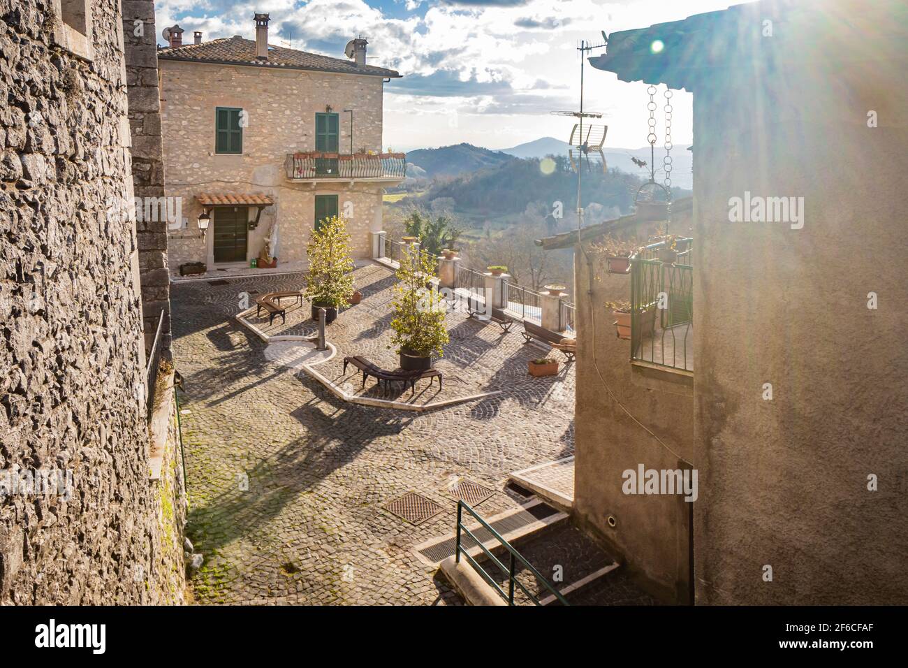 The small medieval village of Capranica Prenestina in Lazio, province of Rome. A small square, with a cobblestone floor, with benches and a fountain, Stock Photo
