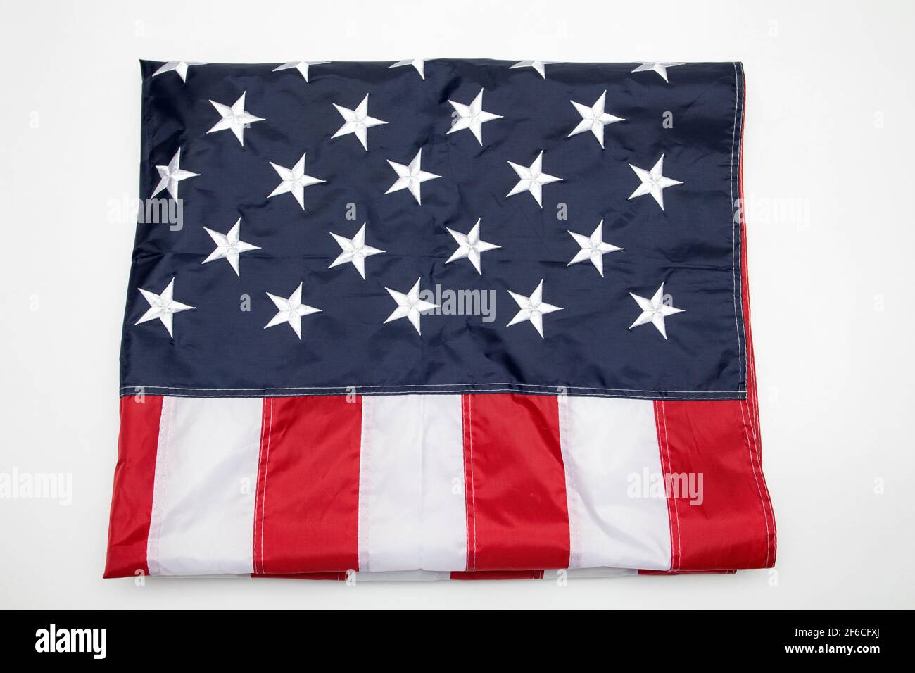 USA flag folded on white background. American flag folded on white background. Memorial day concept Stock Photo