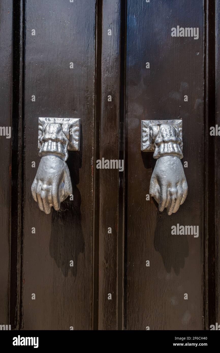 Door knockers in the form of a hand, Algarve, Portugal Stock Photo