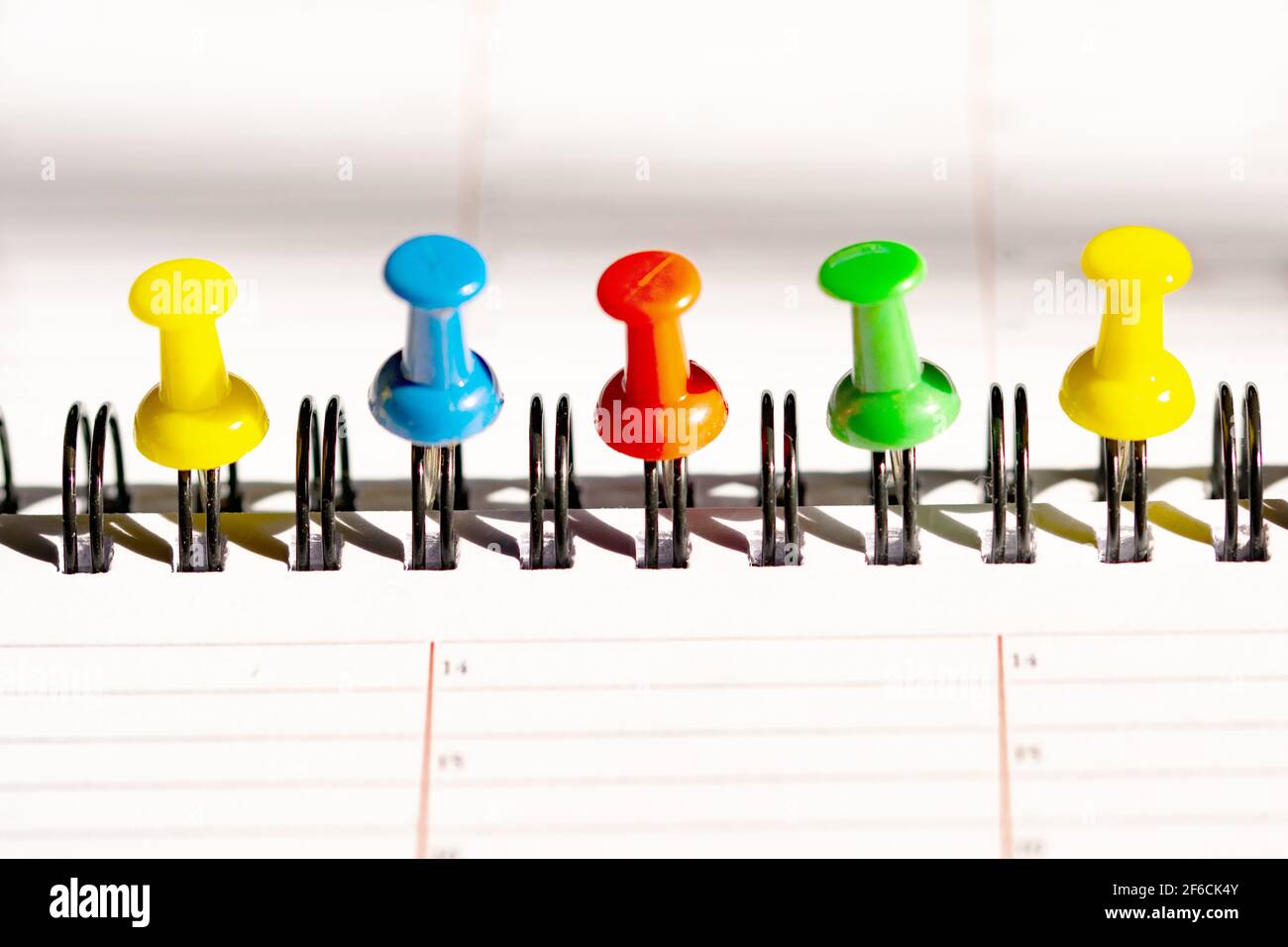 colored push pins on a page on a planning Stock Photo Alamy