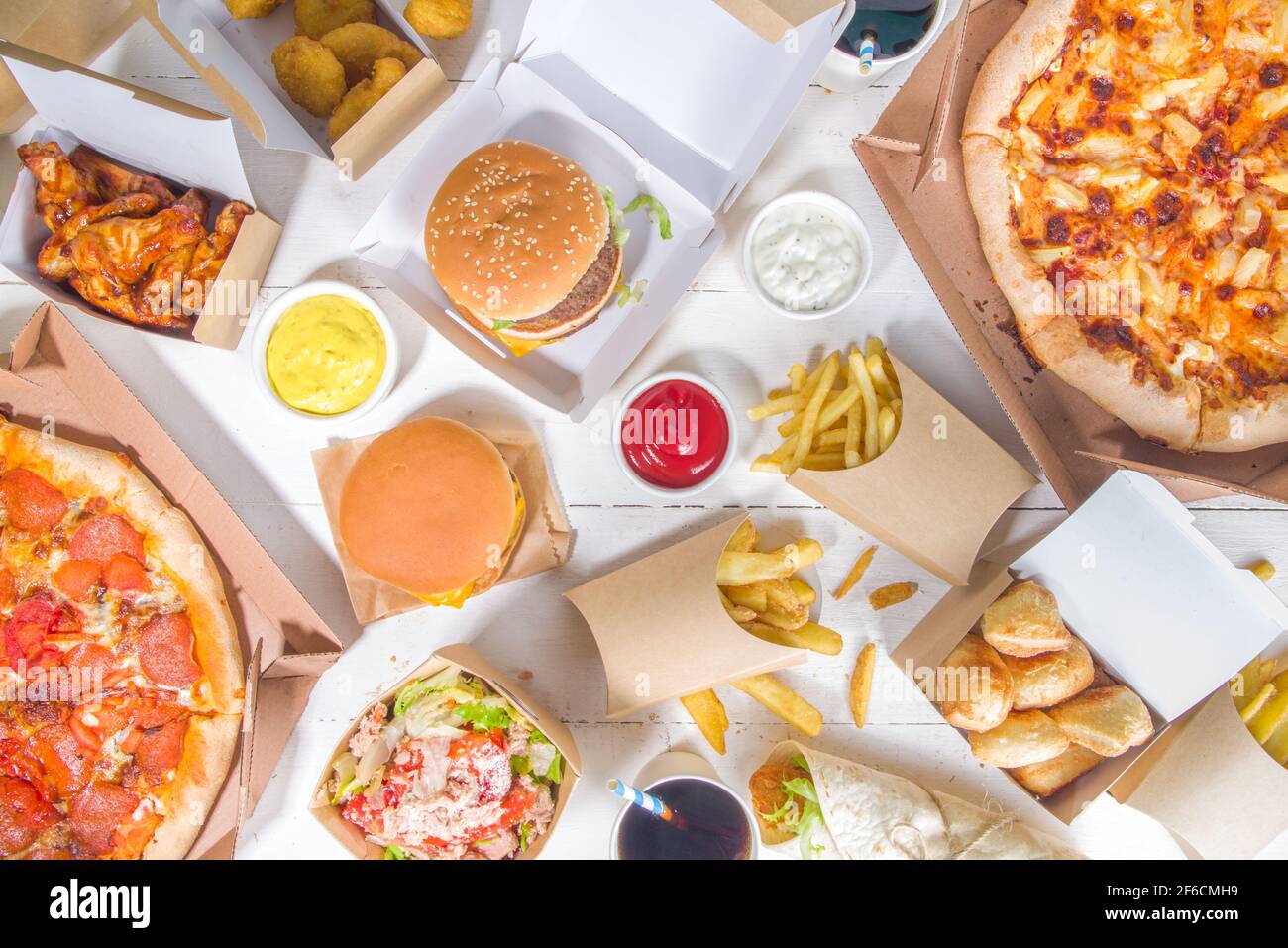 Delivery fastfood ordering food online concept. Large set of assorted take  out foods pizza, french fries, fried chicken nuggets, burgers, salads, chic  Stock Photo - Alamy