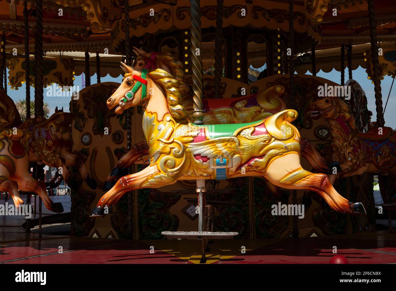 Beautiful empty colorful horse on a merry go round attraction Stock Photo