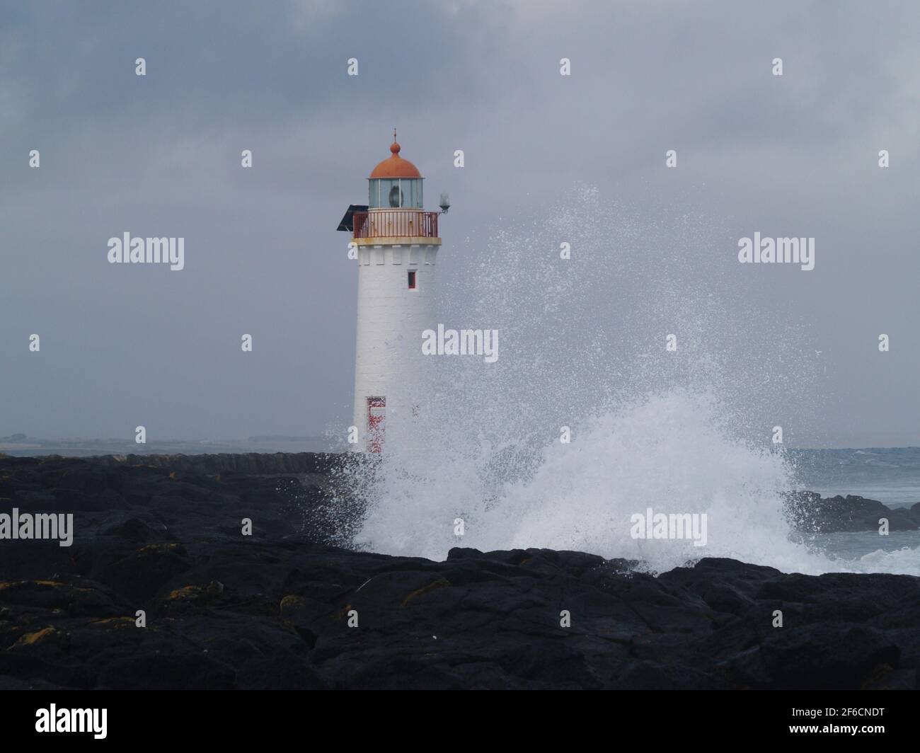 lighthouse smashed by waves port fairy australia Stock Photo