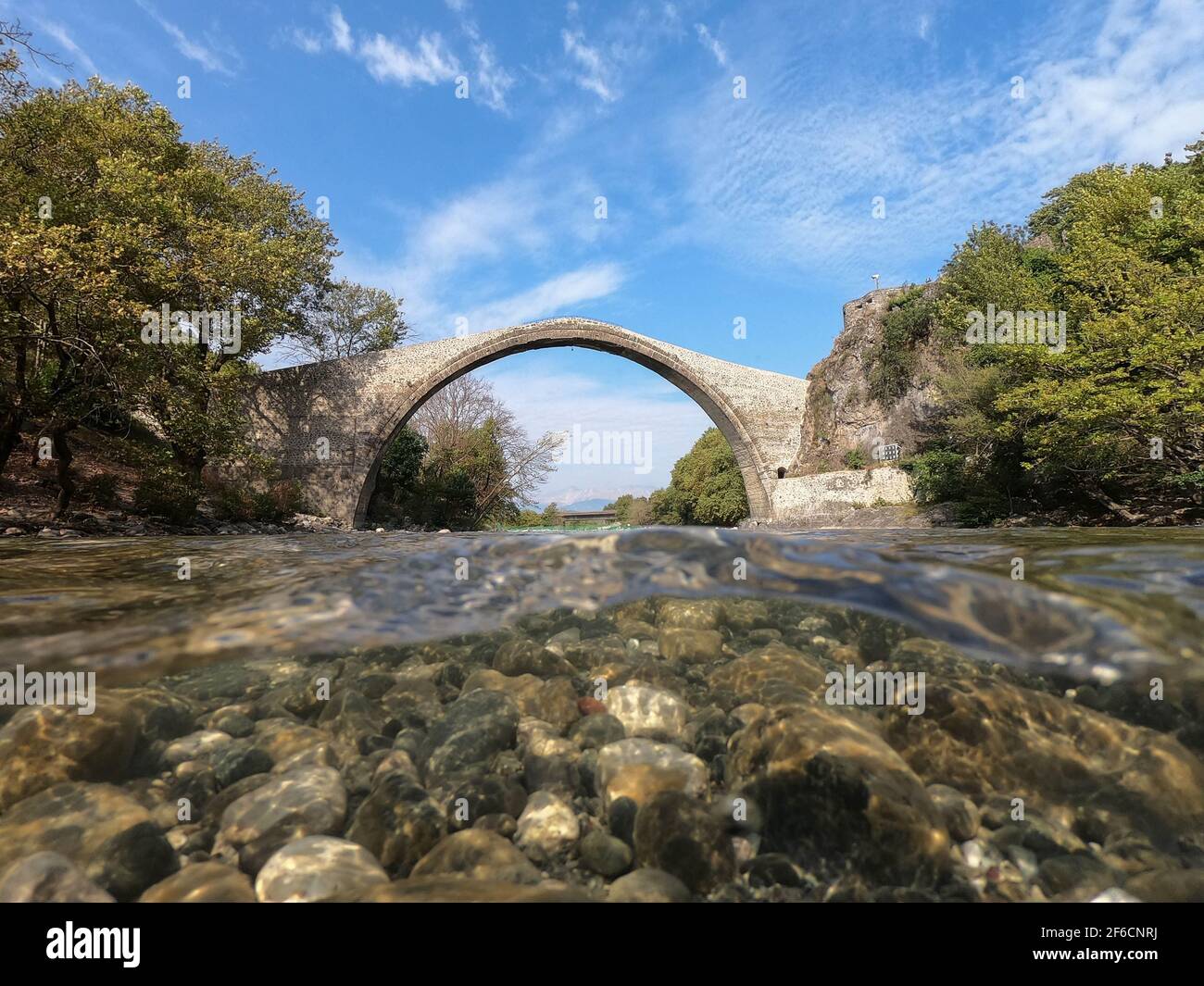 Old stone bridge of Konitsa, Aoos river, half underwater view, Epirus ...