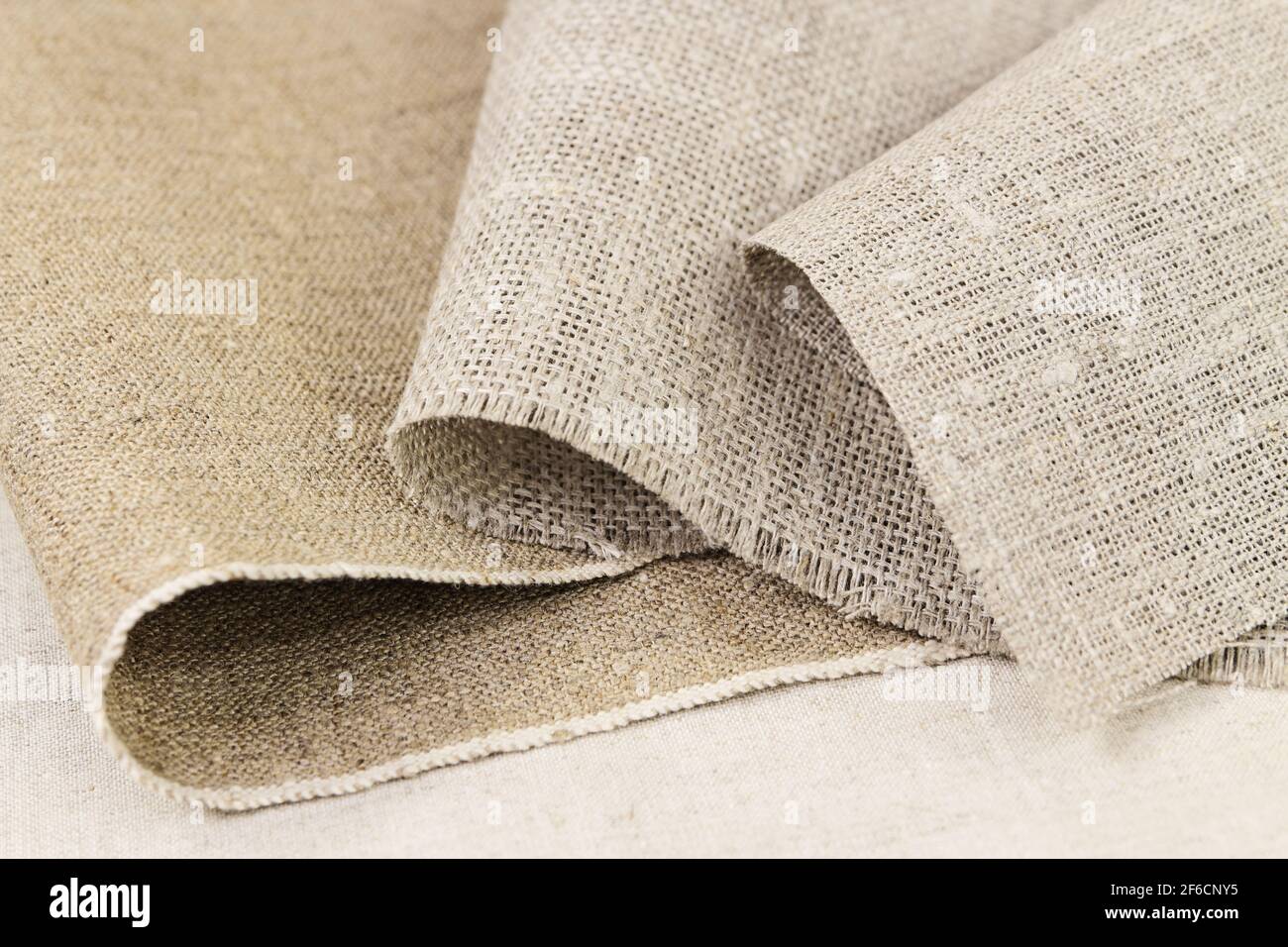 Folds of rough unbleached fabric cotton and flax Stock Photo