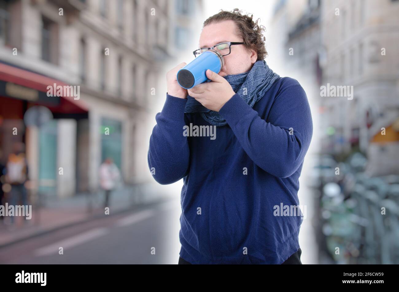 Young attractive guy is drinking a hot drink. Stock Photo