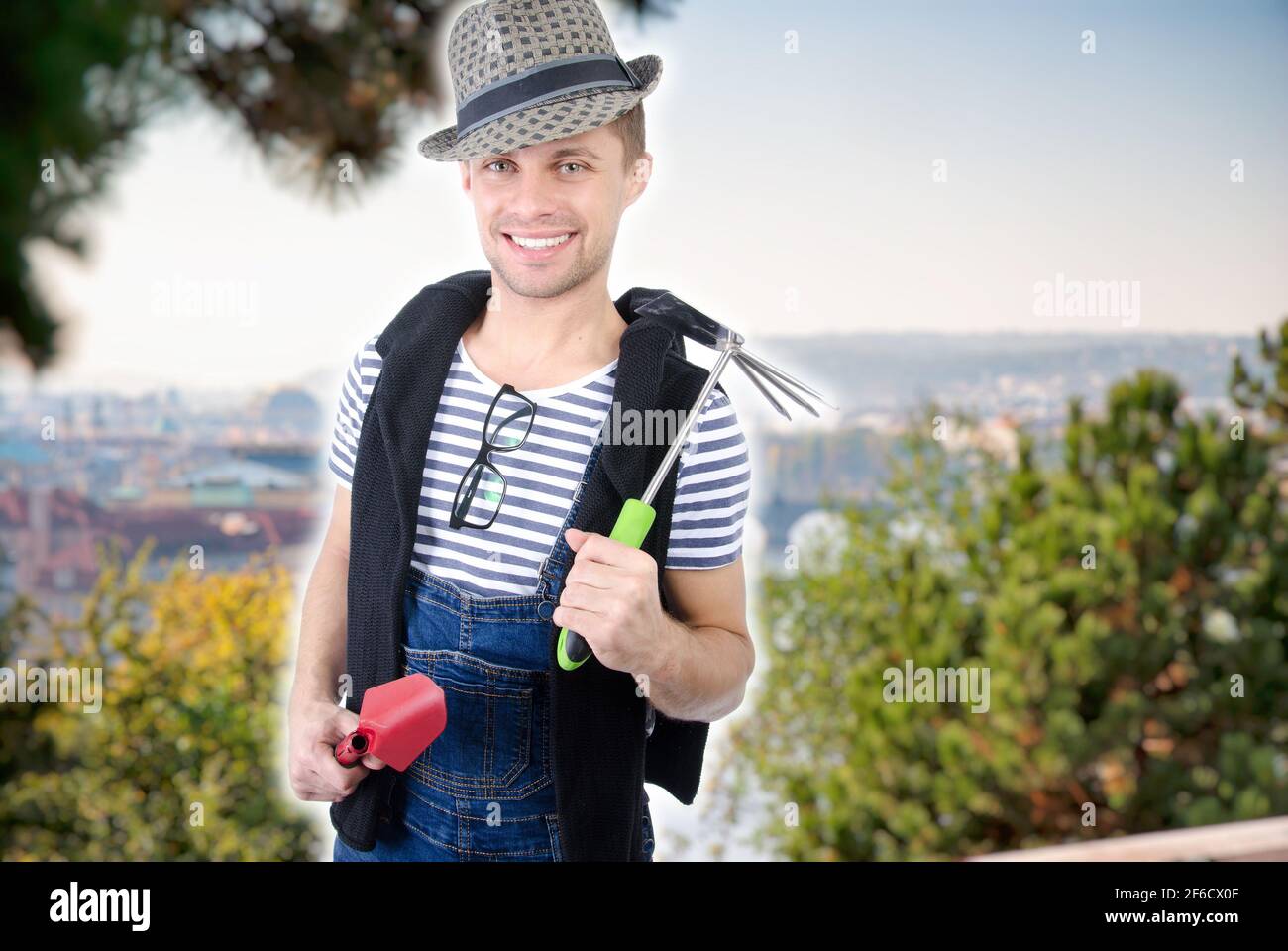 handsome naked gardener posing with tools. Hot shirtless man. Studio