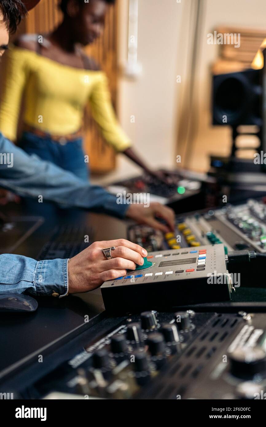 Stock photo of unrecognized male music producer working with black ...