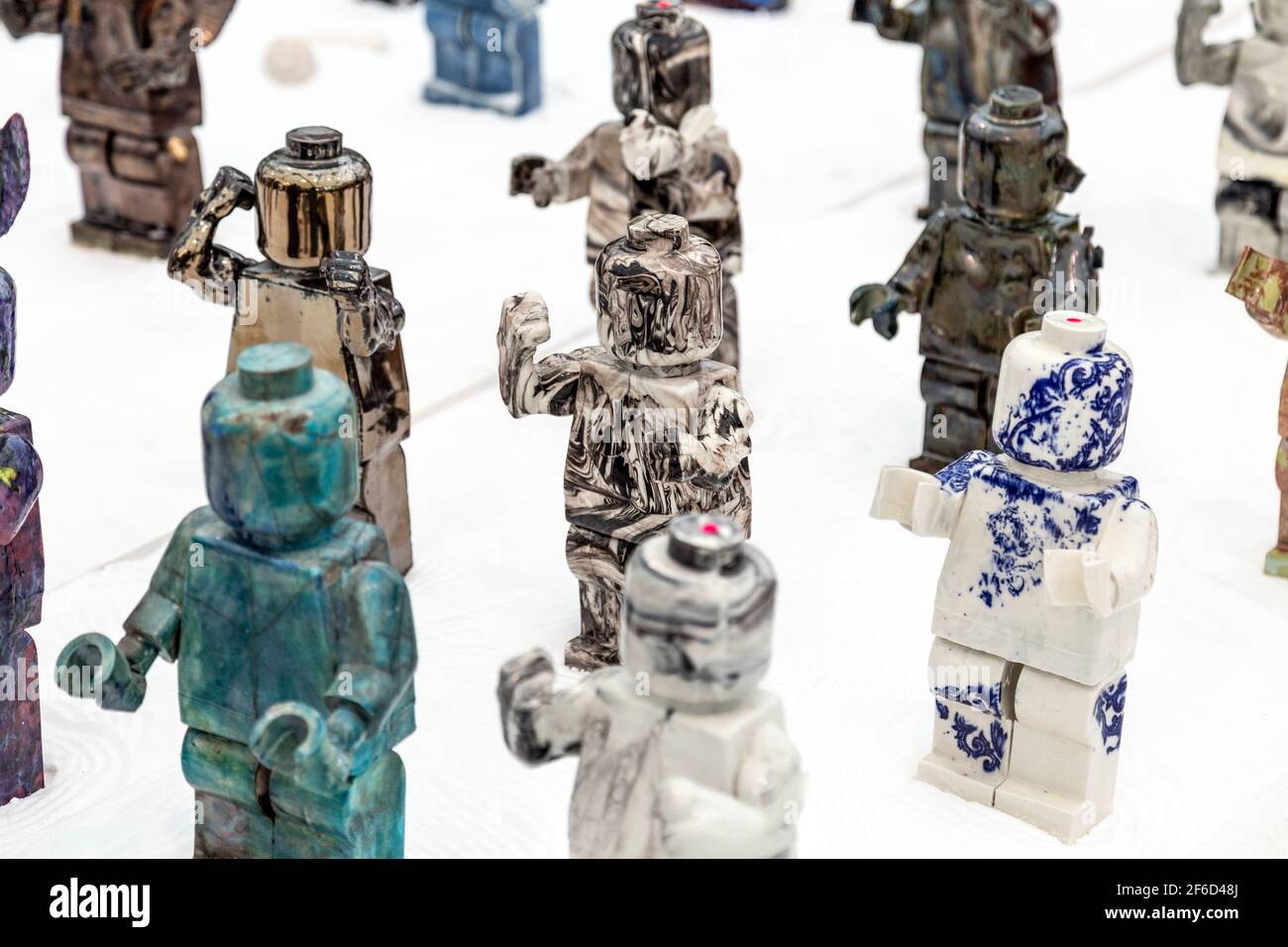 Ceramic lego people sculptures by artist Nam Tran 'Ego Man Army' at The Other Art Fair 2018, London, UK Stock Photo