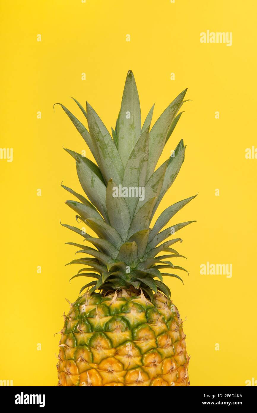 half part of a pineapple on a yellow background Stock Photo
