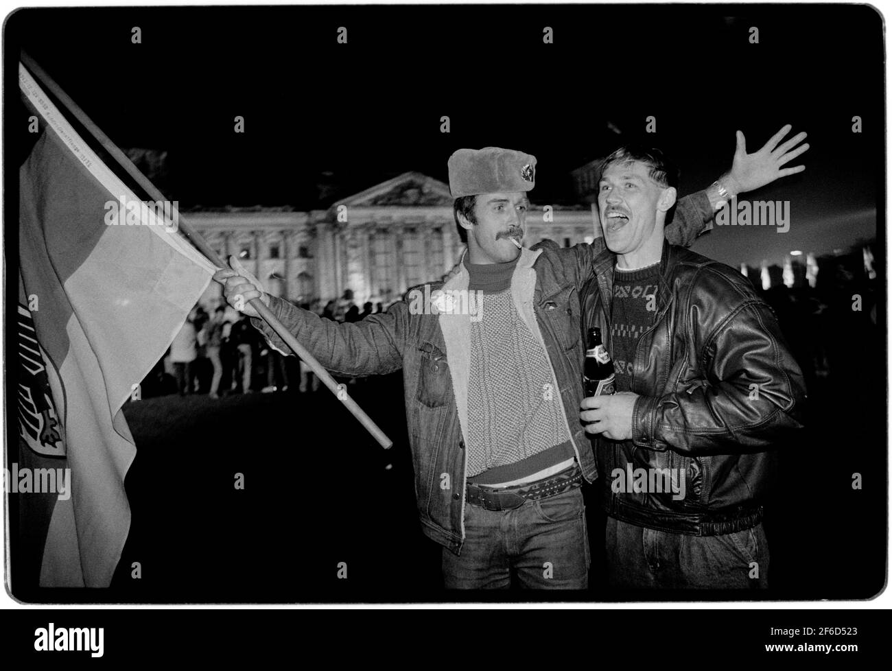 Berlin Germany. Reunification day and night 3 October 1990 East and West  Germans celebrate in front of the Reichstag in Berlin. Wikipedia below:  German reunification (German: Deutsche Wiedervereinigung) was the process in