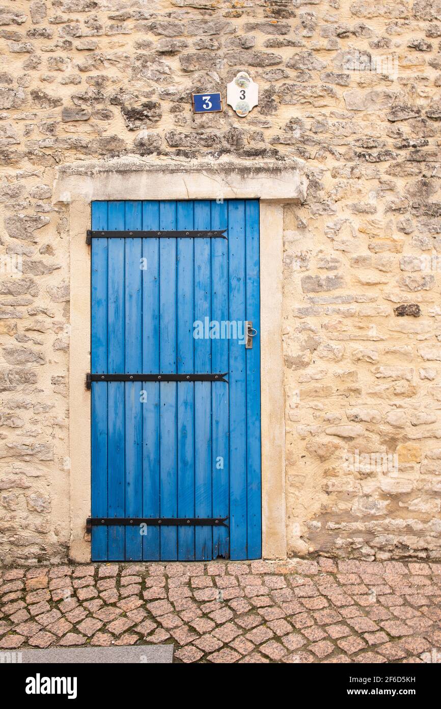 A blue wooden door in a old house in France Stock Photo