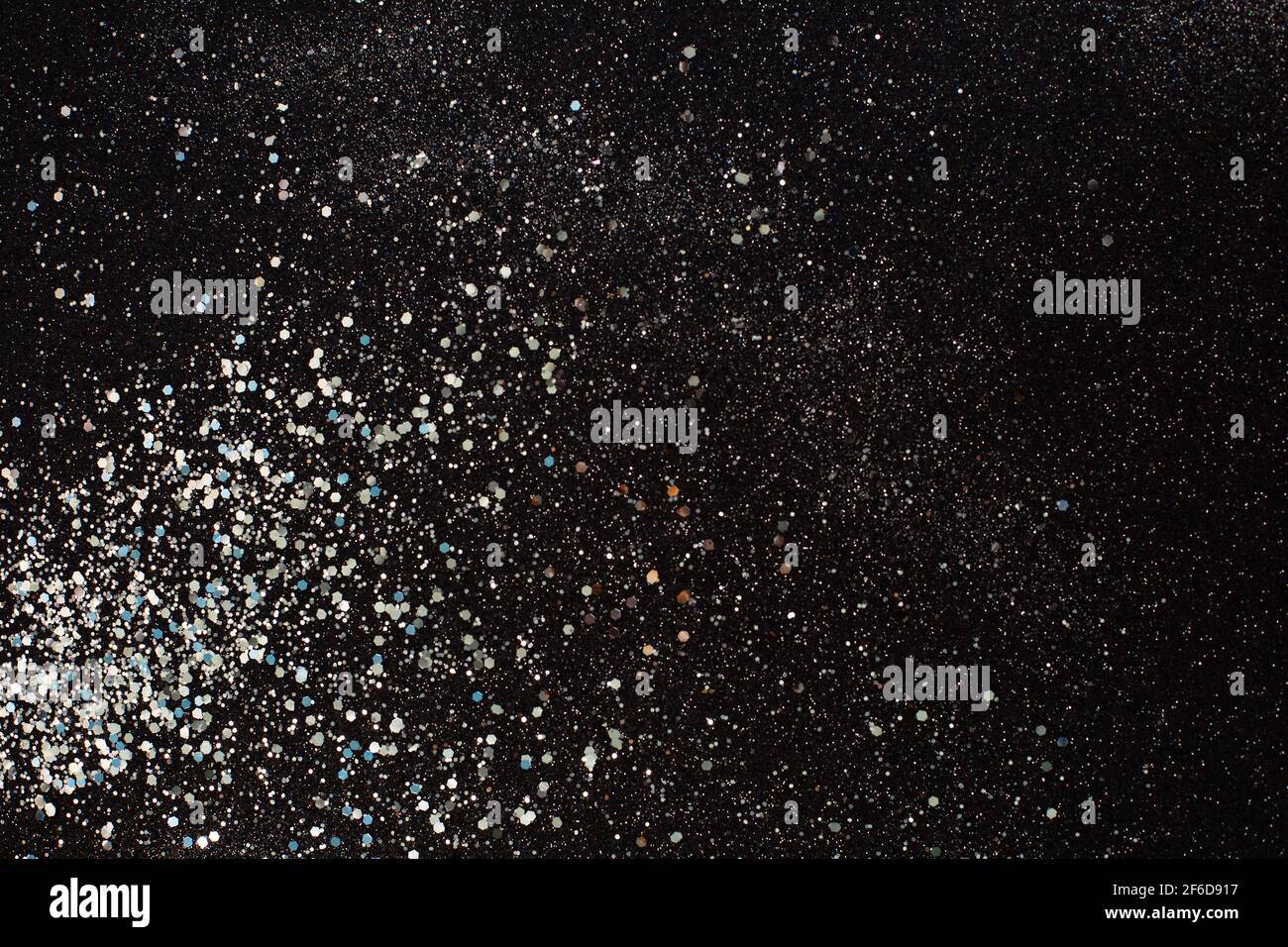Silver glitter texture on a black background. Holiday background. defocused. Stock Photo