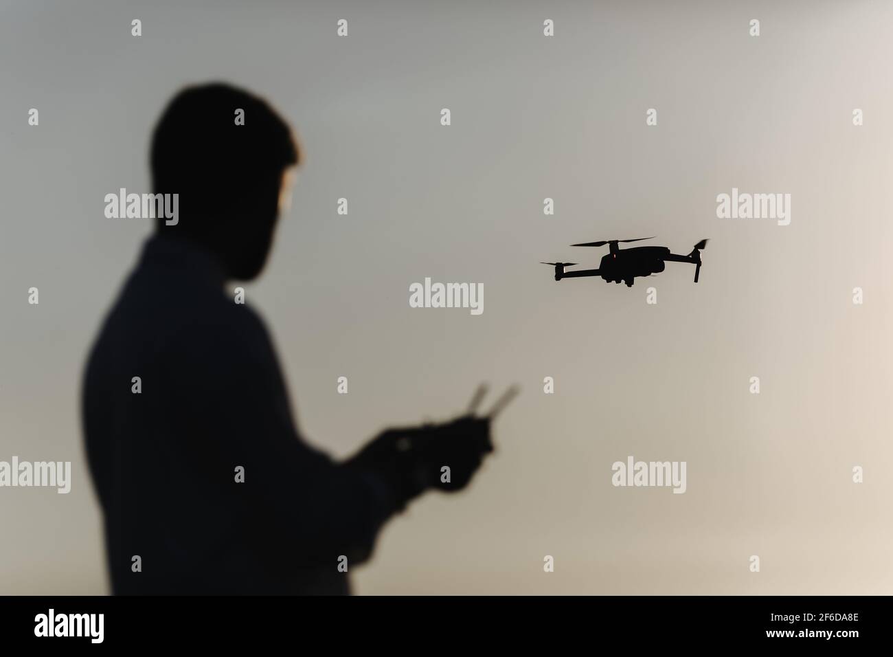Man with quadcopter at field Stock Photo
