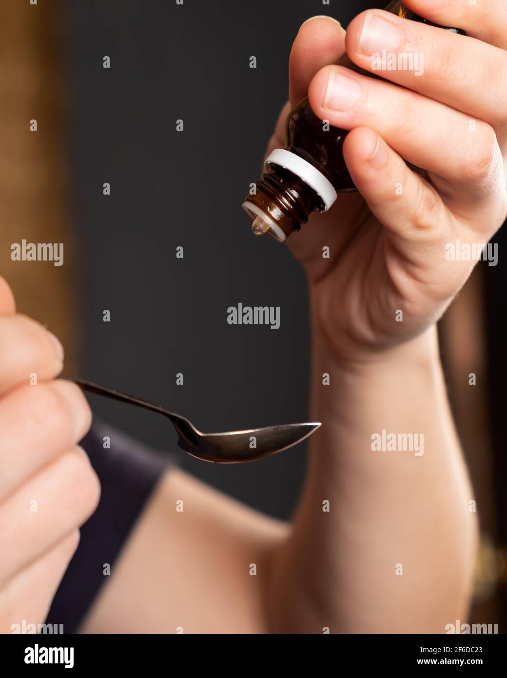 take medicine from a spoon,drip cough syrup Stock Photo