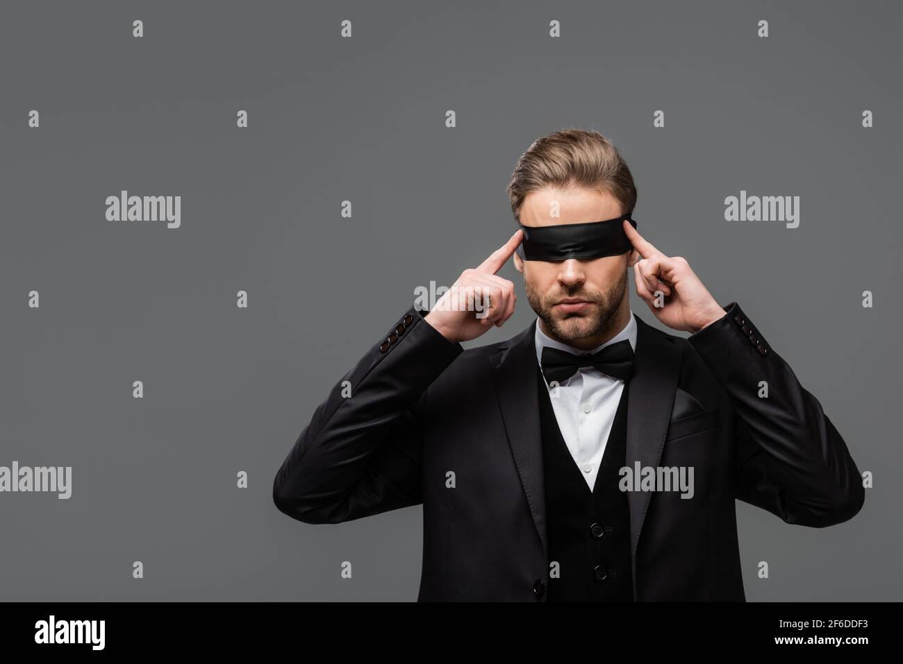 Young Woman Wearing Black Blindfold Isolated On Grey Stock Photo