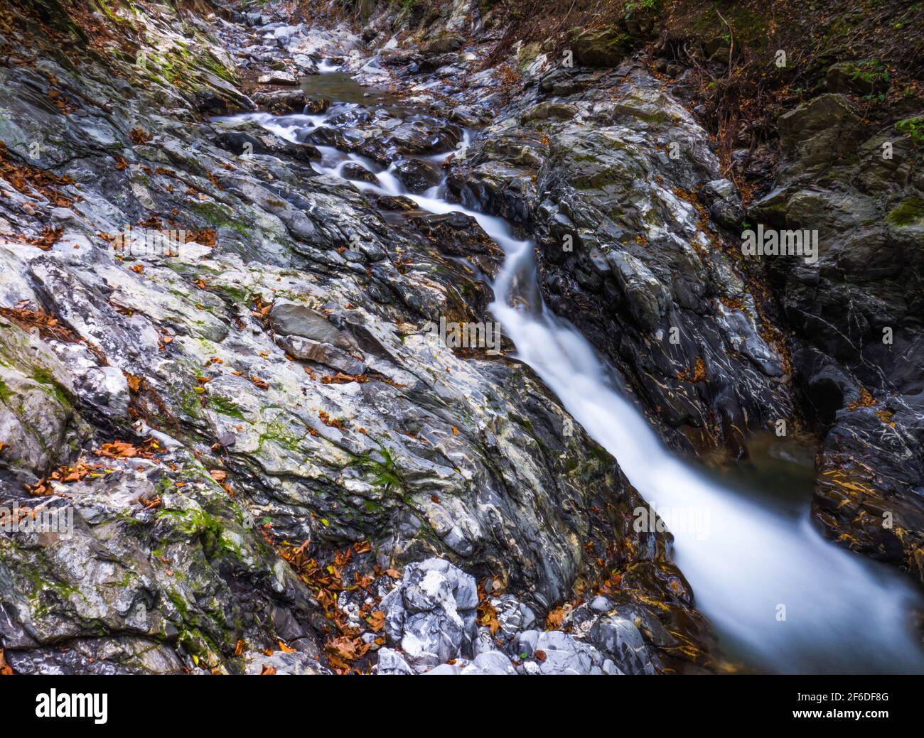 A wide angle shot of a small waterfall in the Carpathian mountains Vrancea county Romania Stock Photo