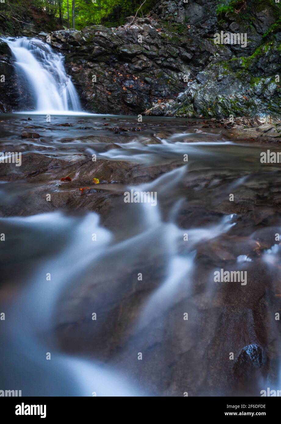 Smooth and silky river with a beautiful waterfall in the background Stock Photo