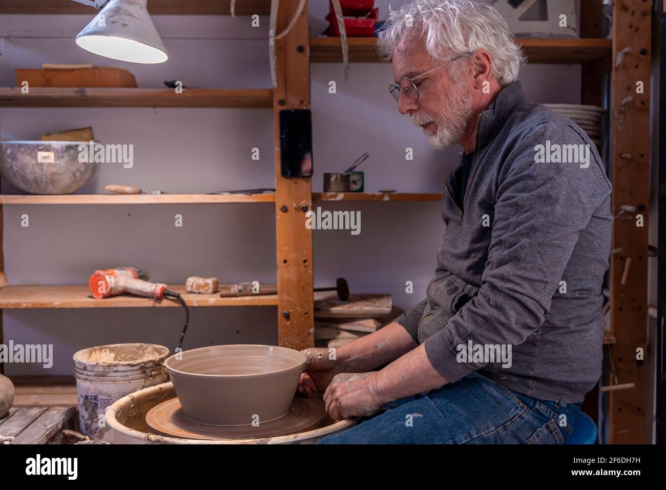 Professional male potter making bowl hi-res stock photography and ...