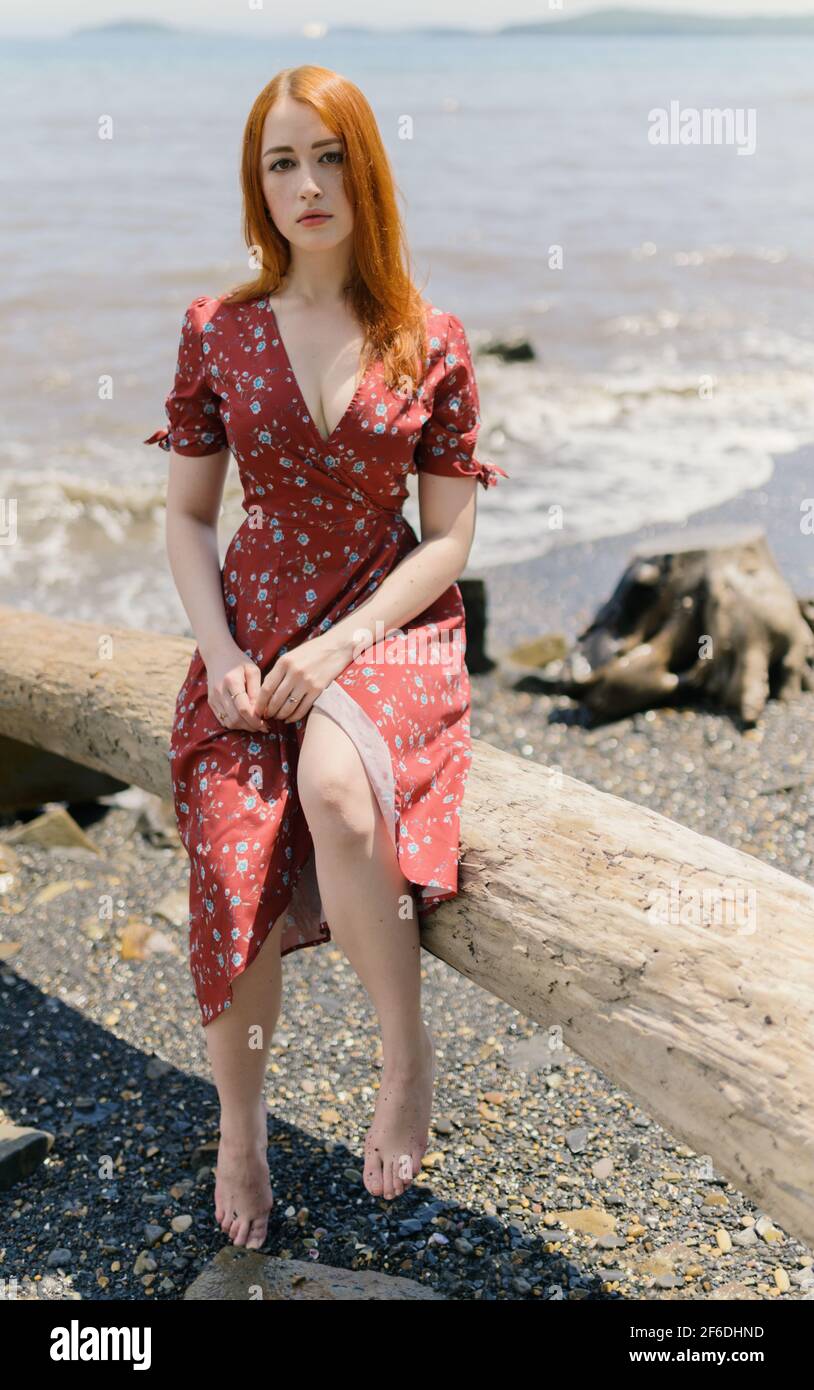 Young redhead woman in white dress enjoys sea Stock Photo - Alamy