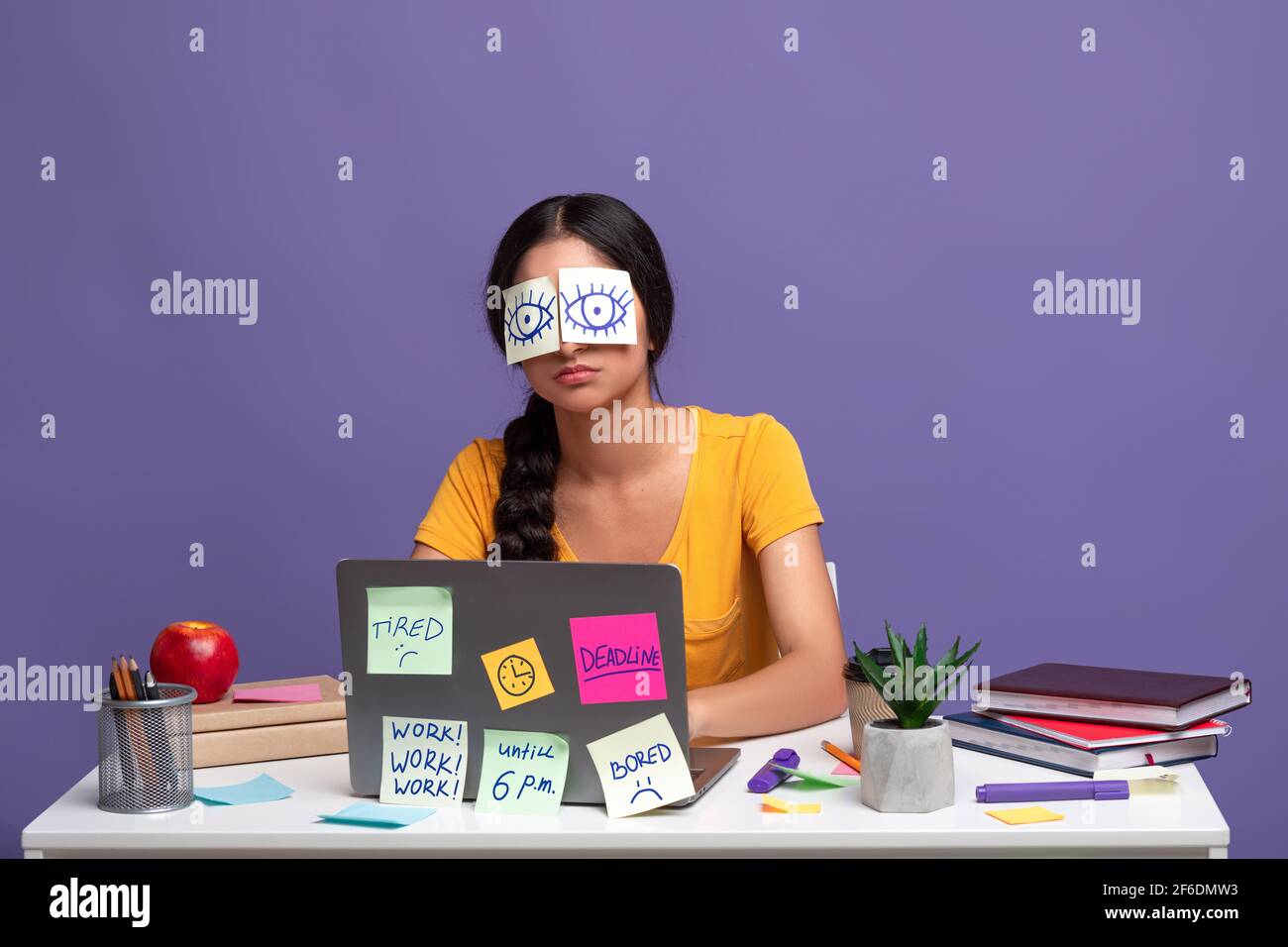 Tired woman sitting at desk with sticky notes on eyes Stock Photo Alamy