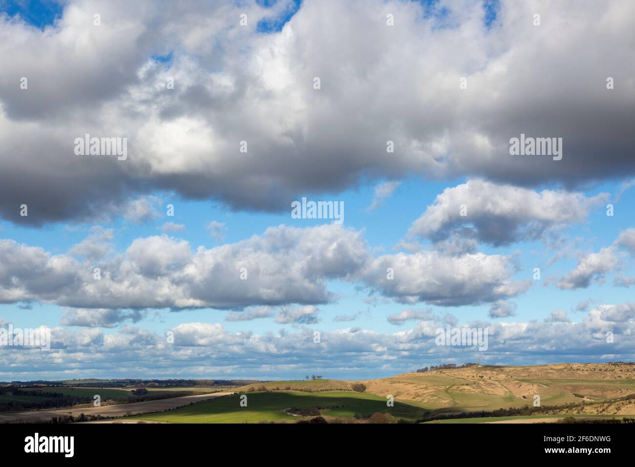 Lines of cumulus clouds in blue sky passing over chalk downland, Cherhill, Wiltshire, England, UK Stock Photo