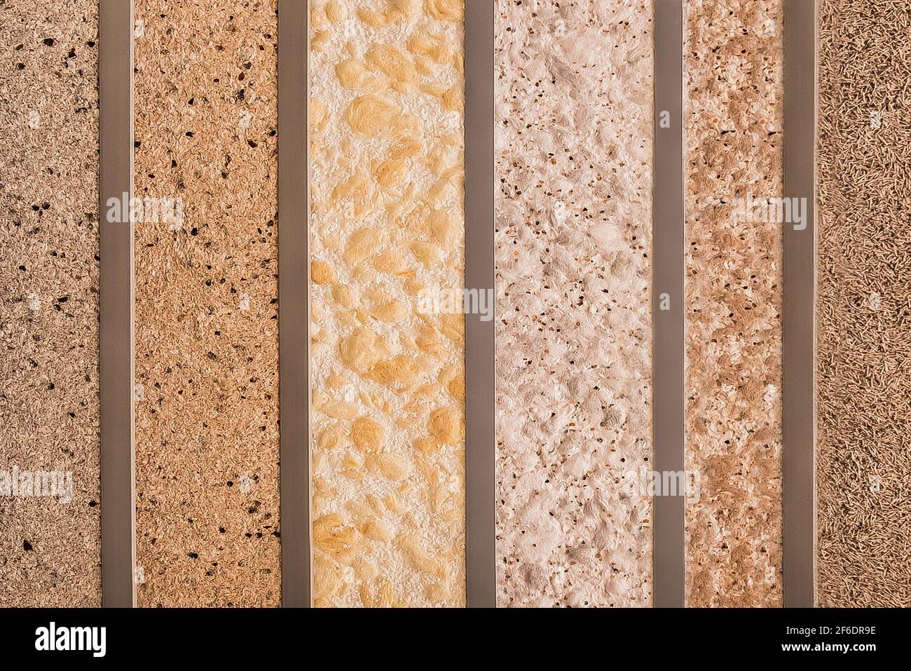 Samples of various multi-colored decorative plasters for interior design in a hardware store. Stock Photo