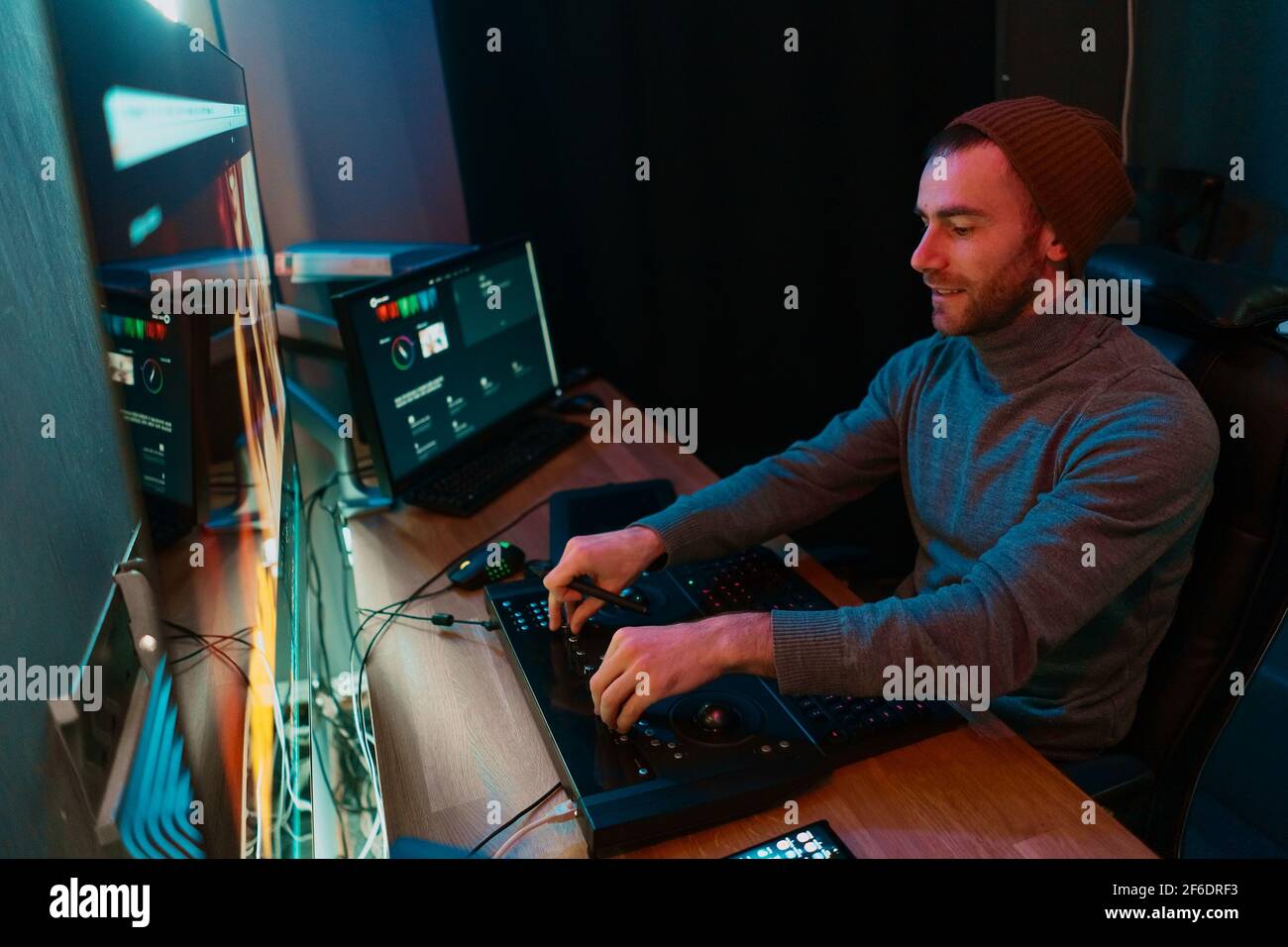 Attractive Male Video Editor Works with Footage or Video on His ...